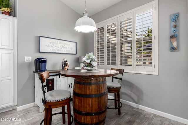 dining room with baseboards and wood finished floors