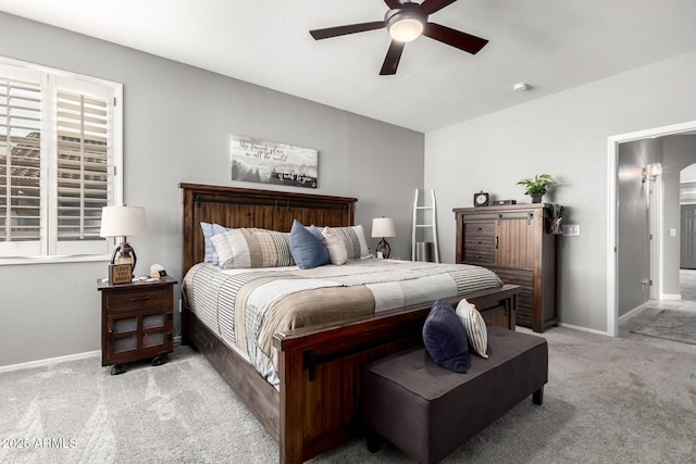 bedroom featuring ceiling fan, baseboards, and light colored carpet