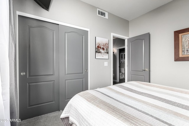 carpeted bedroom with a closet and visible vents