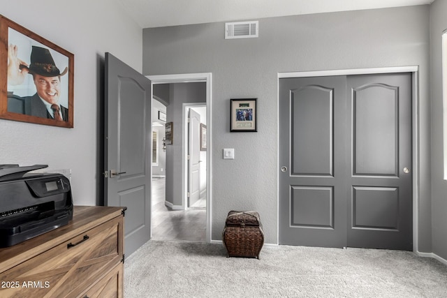 interior space featuring arched walkways, a textured wall, visible vents, and baseboards