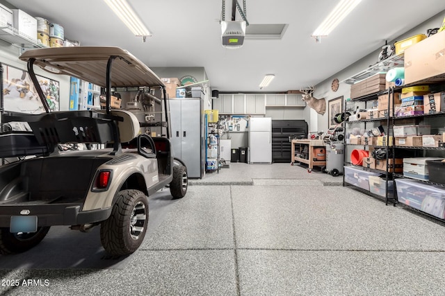 garage with freestanding refrigerator and a garage door opener