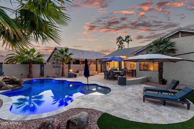 view of pool with a fenced in pool, outdoor dining space, a fenced backyard, and a patio