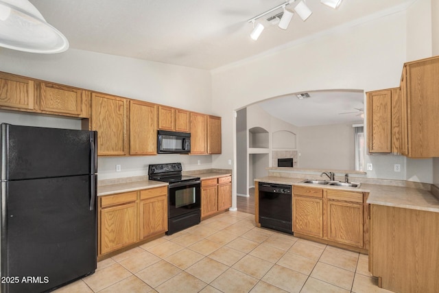 2191 W Goldmine Mountain Dr, Queen Creek, AZ 85144 - kitchen with black appliances, a sink, arched walkways, light tile patterned flooring, and light countertops