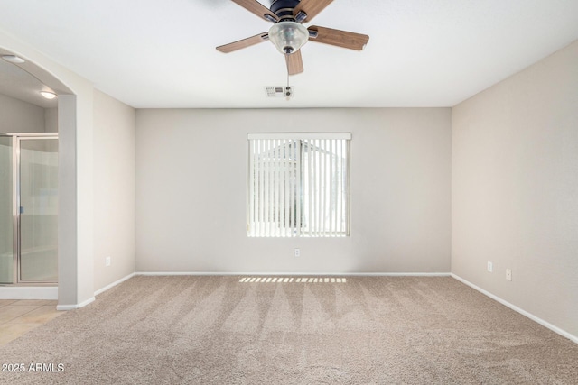 2191 W Goldmine Mountain Dr, Queen Creek, AZ 85144 - unfurnished bedroom with carpet, arched walkways, baseboards, and a ceiling fan