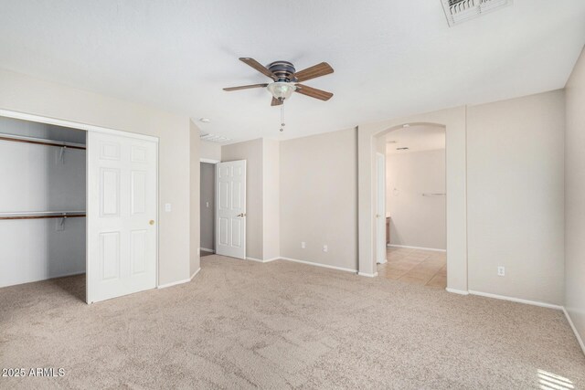 2191 W Goldmine Mountain Dr, Queen Creek, AZ 85144 - unfurnished bedroom featuring arched walkways, carpet, a closet, connected bathroom, and baseboards