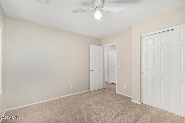 2191 W Goldmine Mountain Dr, Queen Creek, AZ 85144 - unfurnished bedroom with carpet, baseboards, ceiling fan, and a closet