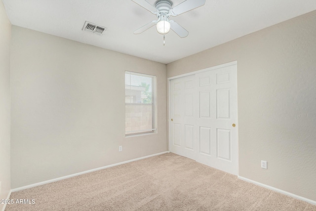 2191 W Goldmine Mountain Dr, Queen Creek, AZ 85144 - unfurnished bedroom with carpet flooring, a closet, baseboards, and a ceiling fan