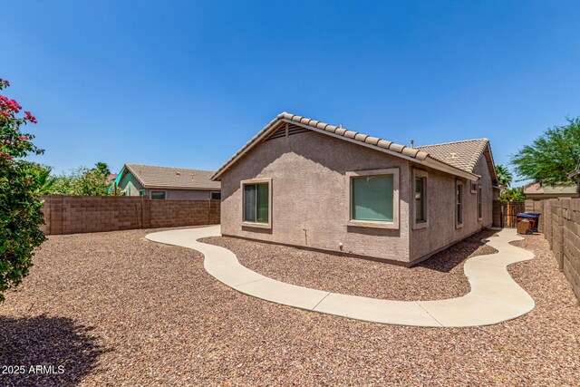 2191 W Goldmine Mountain Dr, Queen Creek, AZ 85144 - view of home's exterior with stucco siding, a tile roof, and a fenced backyard