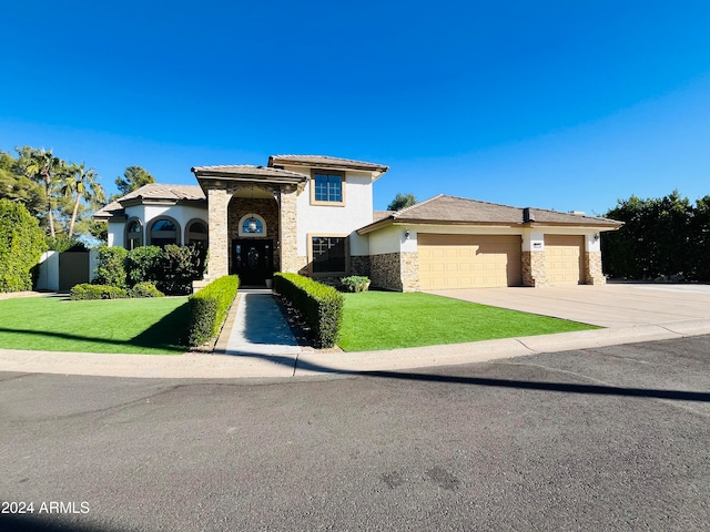 view of front of home with a garage and a front lawn