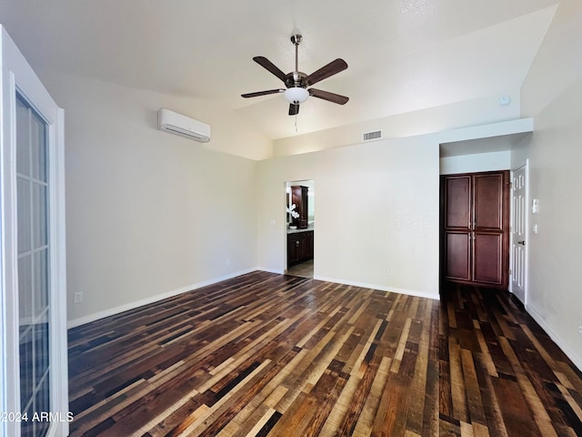 unfurnished room featuring a wall mounted air conditioner, dark hardwood / wood-style floors, ceiling fan, and lofted ceiling