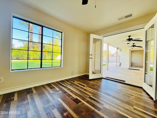 doorway featuring ceiling fan, french doors, and dark wood-type flooring