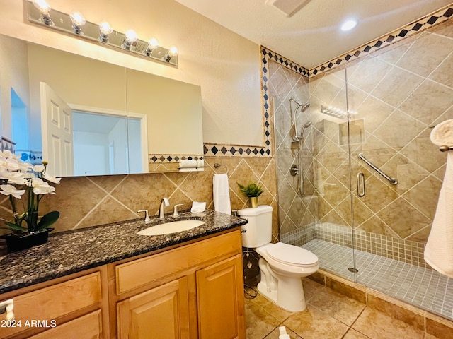 bathroom with vanity, tile patterned flooring, decorative backsplash, toilet, and a shower with shower door