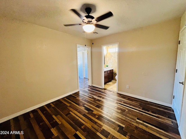 spare room with ceiling fan and dark hardwood / wood-style floors