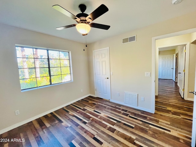 unfurnished bedroom featuring dark hardwood / wood-style floors and ceiling fan