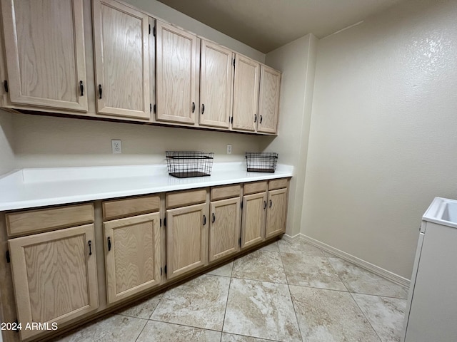 laundry area featuring light tile patterned floors