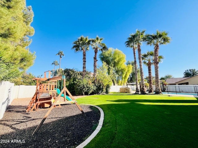 view of yard with a playground and a pool