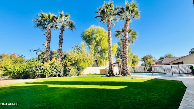 view of yard with a fenced in pool