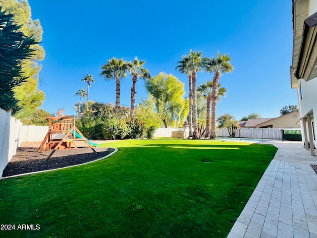 view of yard with a playground and a patio