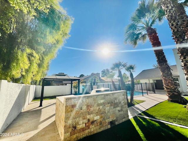 view of yard with a gazebo, a fenced in pool, and a patio area