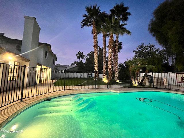 view of pool at dusk