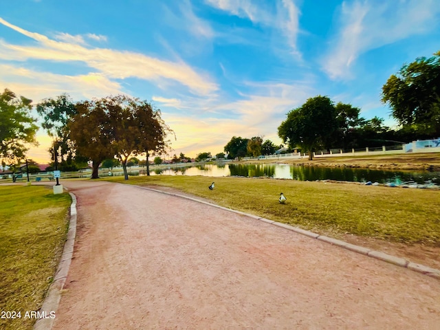 view of home's community featuring a water view and a lawn