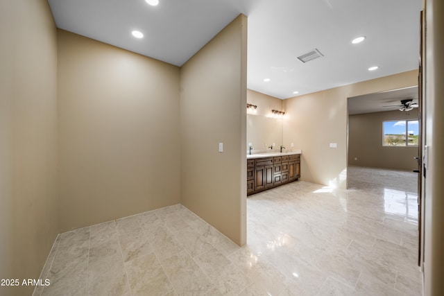 unfurnished room featuring indoor bar and ceiling fan