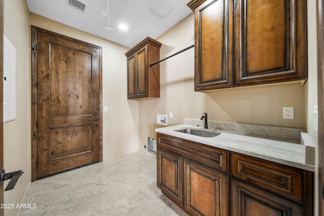 laundry room featuring cabinets, washer hookup, and sink