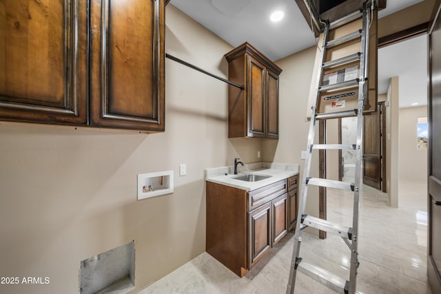 clothes washing area with washer hookup, cabinets, and sink