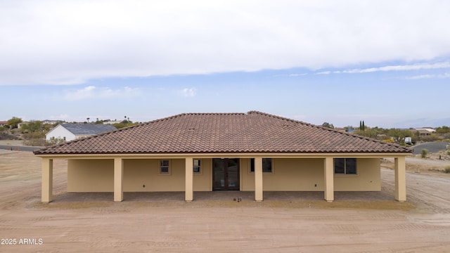 back of property featuring french doors and a patio