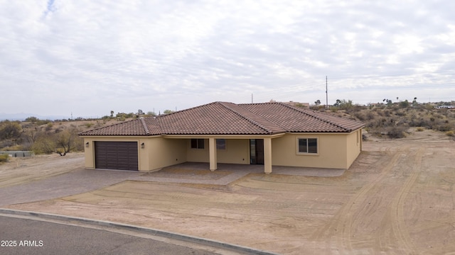 mediterranean / spanish house featuring a garage