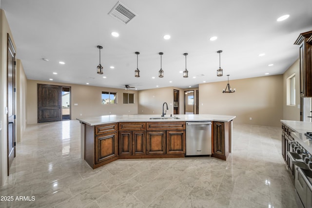 kitchen featuring pendant lighting, a spacious island, sink, ceiling fan, and stainless steel appliances