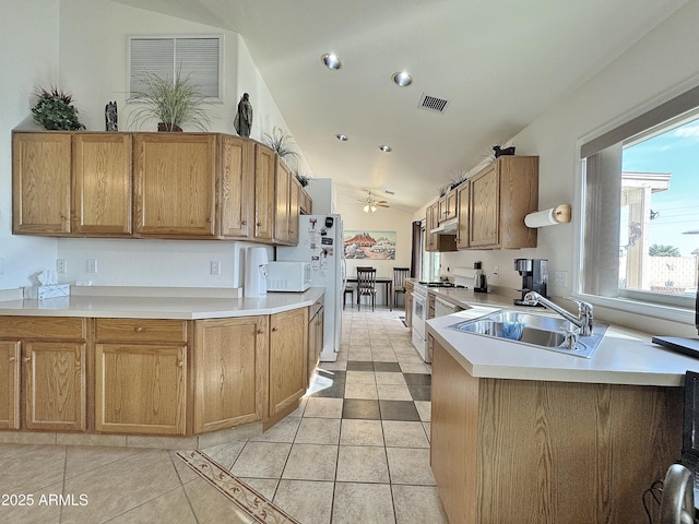 kitchen with vaulted ceiling, sink, light tile patterned floors, ceiling fan, and white appliances