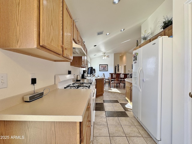 kitchen with ceiling fan, white appliances, lofted ceiling, and light tile patterned floors