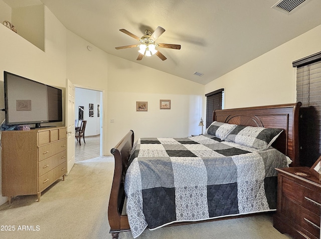 bedroom with ceiling fan, light colored carpet, and lofted ceiling