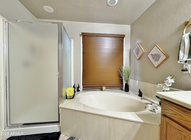 bathroom featuring vanity and shower with separate bathtub