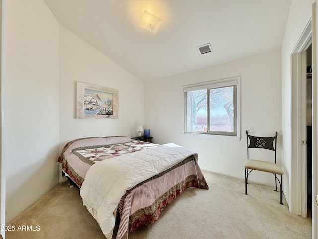 carpeted bedroom with vaulted ceiling