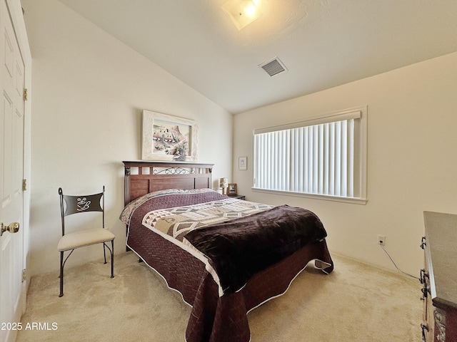 bedroom featuring lofted ceiling and light colored carpet