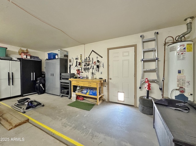 garage with a workshop area and gas water heater