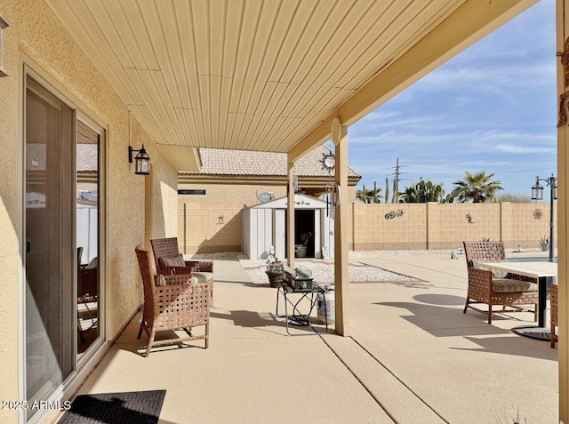 view of patio / terrace featuring a storage shed