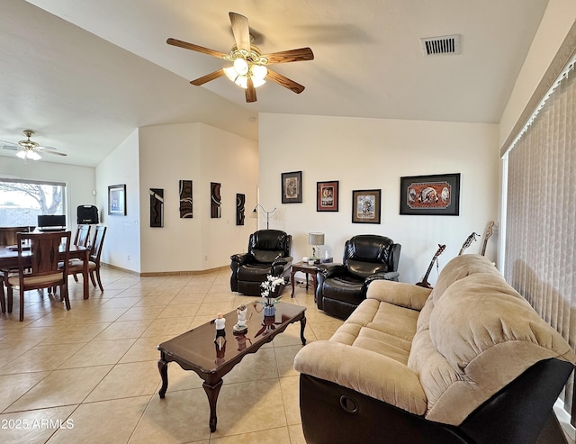 living room featuring light tile patterned flooring, lofted ceiling, and ceiling fan