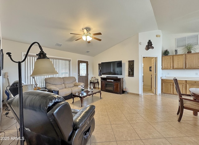 living room with ceiling fan, high vaulted ceiling, and light tile patterned floors