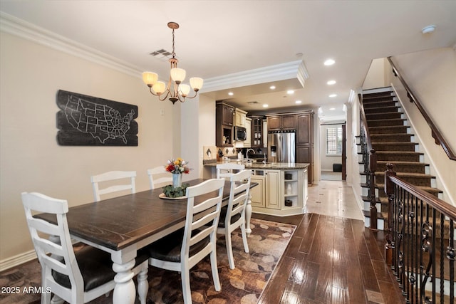 2470 E Roma Ave, Phoenix, AZ 85016 - dining area with crown molding, a chandelier, stairway, dark wood finished floors, and recessed lighting