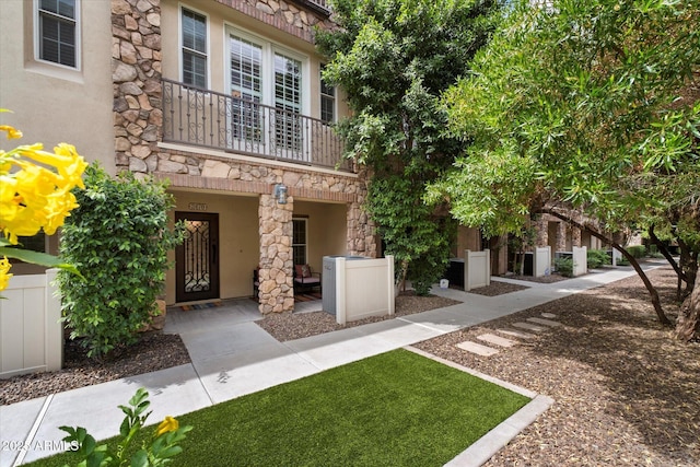 2470 E Roma Ave, Phoenix, AZ 85016 - view of front of property featuring a balcony, stone siding, and stucco siding