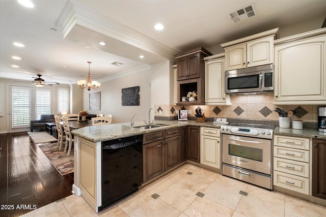 2470 E Roma Ave, Phoenix, AZ 85016 - kitchen featuring appliances with stainless steel finishes, cream cabinets, crown molding, a peninsula, and backsplash