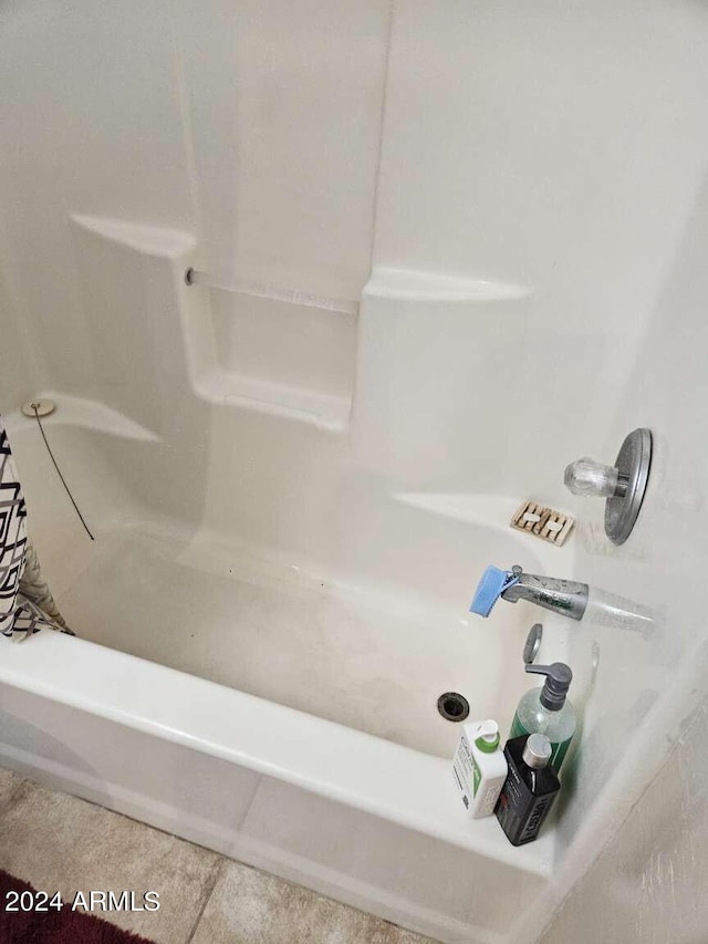 bathroom with shower / bathtub combination and tile floors