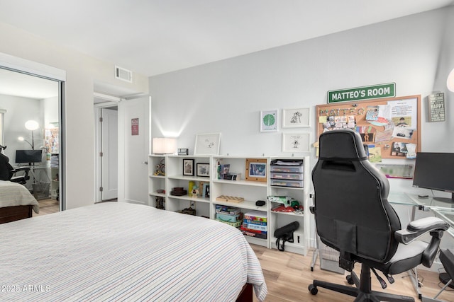 bedroom featuring light wood-type flooring and visible vents