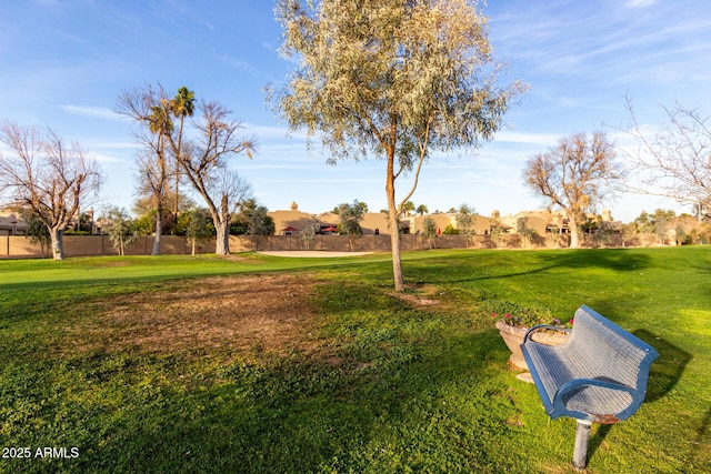 surrounding community with a residential view, a yard, and fence