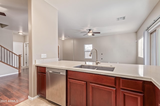 kitchen with sink, stainless steel dishwasher, ceiling fan, and light tile patterned floors