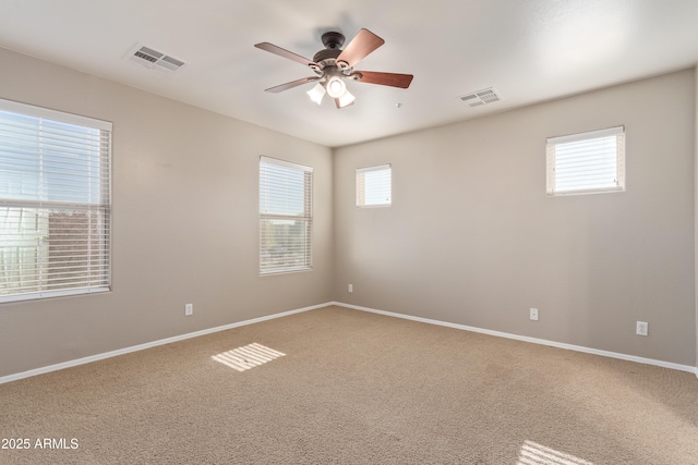 carpeted spare room featuring ceiling fan