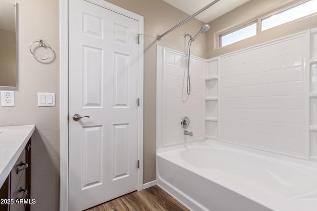 bathroom featuring vanity, wood-type flooring, and bathing tub / shower combination